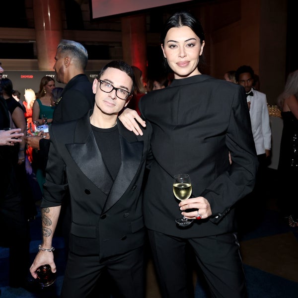Christian Siriano and Lauren Chan, dressed in stylish black suits, pose together at the DKMS New York Gala 2025, holding drinks and smiling. Other elegantly dressed guests are visible in the background. Christian Siriano and Lauren Chan, dressed in stylish black suits, pose together at the DKMS New York Gala 2025, holding drinks and smiling. Other elegantly dressed guests are visible in the background.