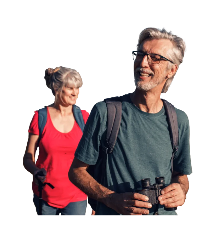 Couple with backpacks and binoculars out for a walk.