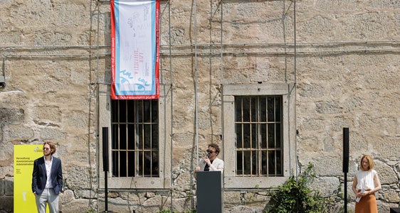 Festung Franzensfeste: Bei der Ausstellungseröffnung von „Brücken durch die Zeit“ mit (von links) Patrick Moser (Museumsdidaktik), Direktor Emanuel Valentin und Kuratorin Esther Erlacher war auch die Euregio-Museumsjahr-Fahne zu sehen. (Foto: Luca Guadagnini)