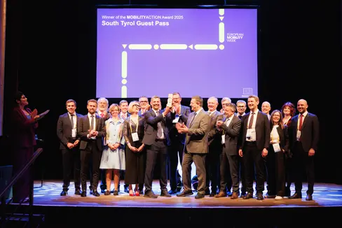 Der Südtirol Guest Pass wurde im Rahmen der Mobility Action Awards 2025 der Europäischen Kommission als bestes europäisches Mobilitätsprojekt ausgezeichnet. Auf der Bühne: die Südtiroler Delegation mit Mobilitätslandesrat Daniel Alfreider. (Foto: LPA/Ivan Brentegani)