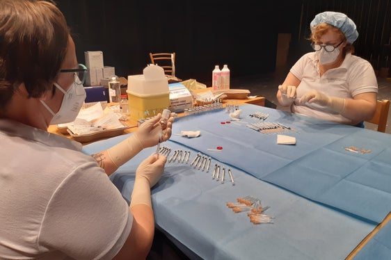 Viele helfende Hände auch hinter den Kulissen: Auch die Vorbereitung der Spritzen musste gut organisiert sein. (Foto: LPA/Guido Steinegger)
