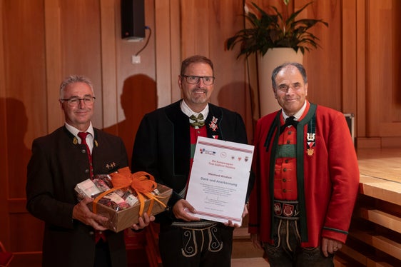 Premiato per aver diretto per sei volte l'Orchestra giovanile di fiati dell'Euregio: Meinhard Windisch (al centro) con Elmar Juen, presidente dell'Associazione tirolese di musica per fiati (a sinistra) e Pepi Ploner, presidente dell'Associazione bande musicali dell'Alto Adige (a destra). (Foto: ASP/Tiberio Sorvillo)