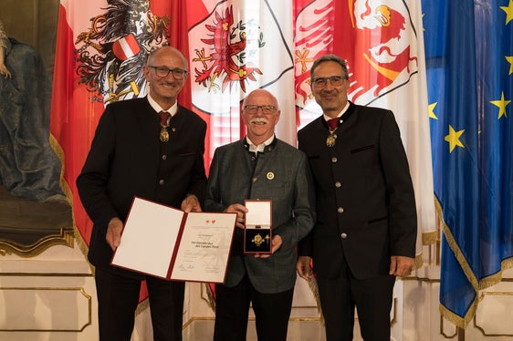 Mit der Verdienstkreuz des Landes Tirol von den Landeshauptleuten Anton Mattle (links) und Arno Kompatscher (rechts) ausgezeichnet: Georg Simeoni (Mitte) aus Neumarkt. (Foto: Land Tirol/Sedlak)