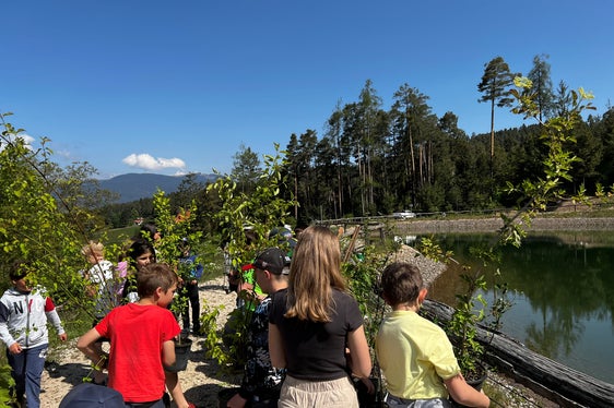 Un'attività diversa rispetto alla quotidianità scolastica e un impegno per la natura e il futuro: gli alunni della scuola elementare di Aica di Fiè hanno partecipato con entusiasmo alla campagna di piantumazione di siepi presso il lago artificiale di Umes (Foto: ASP/Marcella Morandini)