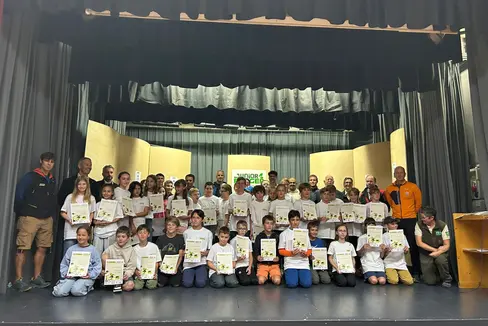 45 naturbegeisterte Kinder zwischen 10 und 11 Jahren haben am 2. August bei einer Feierstunde im Vereinssaal von Wengen ihre Naturpark Junior Ranger 2025-Diplome bekommen. Anwesend waren zahlreiche Ehrengäste wie Landesrat Peter Brunner (stehend, 2.v.l.) (Foto: LPA/Ralf Pechlaner)