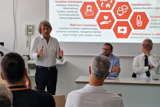 Es gelte, von einer krankenhauszentrierten Versorgung weg und verstärkt zu einer gesundheitsfördernden Versorgung hinzukommen unterstrich Gesundheitslandesrat (vorne links mit dem Verwaltungsdirektor des Sanitätsbetriebs Luca Armanaschi und Ressortdirektor Michael Mayr im Gespräch mit den Führungskräften und Mitarbeitenden im Schwerpunktkrankenhaus Meran. (Foto: LPA/Angelika Schrott)