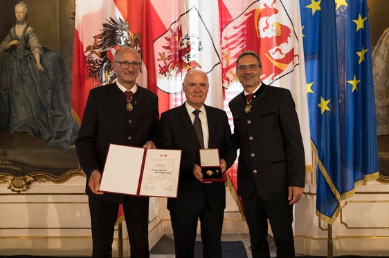 Mit der Verdienstkreuz des Landes Tirol von den Landeshauptleuten Anton Mattle (links) und Arno Kompatscher (rechts) ausgezeichnet: Karl Werner (Mitte) aus Riffian. (Foto: Land Tirol/Sedlak)