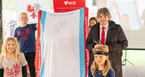 Primo messaggio sulla bandiera itinerante con le “richieste dei musei alla società”: in linea con il motto “guardare oltre”, il direttore della Hofburg Peter Schwienbacher ha disegnato un contadino con una lampada. (Foto: USP/Daniel von Johnston)