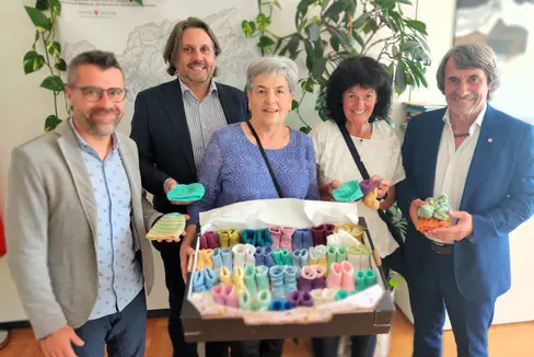 Winzig klein und mit viel Liebe gestrickt: Gesundheitslandesrat Hubert Messner (1.v.r.), Pflegekoordinator Daniele Gianotti (1.v.l.), Primar Alex Staffler (2.v.l.) erhielten in der Neonatologie Bozen handgefertigte Frühchenkleider als Zeichen der Wertschätzung für die Kleinsten – und das engagierte Team von Regina Marth (v.l.nr.) und Irene Borek. (Foto: LPA/ Gesundheitsressort)