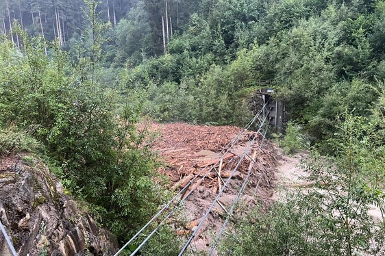 La barriera che attraversa la gola della Rienza è piena di legname e di materiale trasportato dalla corrente che ora è in fase di sgombero da parte degli operatori dei Bacini montani (Foto: ASP/Ufficio sistamazione bacini montani Est dell'Agenzia per la Protezione civile)