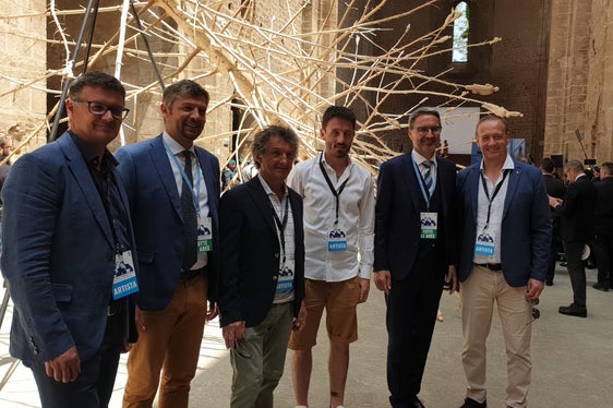 Il presidente Kompatscher (secondo da destra) e l'assessore Alfreider (secondo da sinistra) posano con gli artisti Gerald Moroder, Peter Demetz, Gregor Prugger e Fabrizio Biz Senoner davanti a L'albero dei tutti di Gregor Prugger (Foto: ASP)