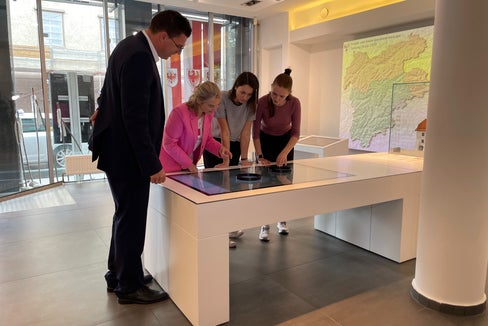 Matthias Fink, rappresentante del Land Tirolo nel Segretariato generale dell’Euregio, guida i visitatori interessati all'interno dell'Infopoint dell'Euregio a Innsbruck. (Foto: Euregio)