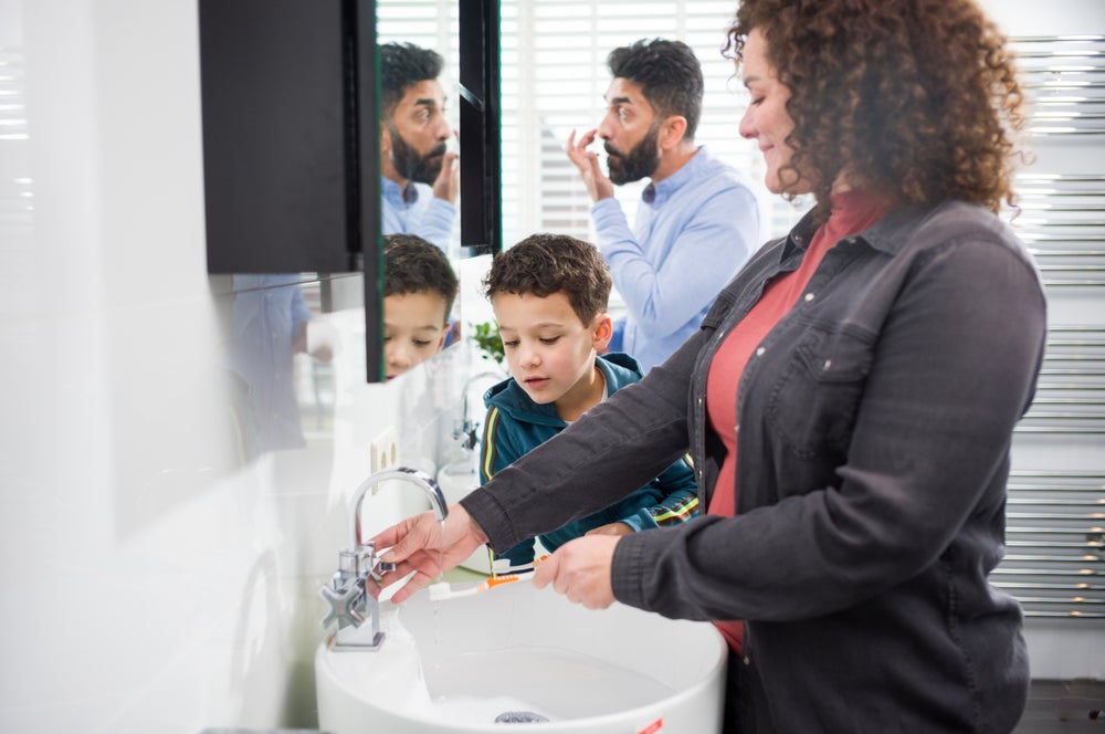 Familie in de badkamer, klaar om tanden te poetsen.