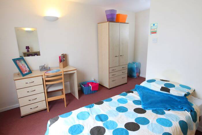 Bedroom with single bed and desk area