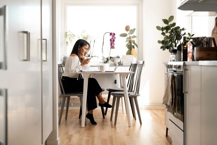 Woman working from home at her kitchen table