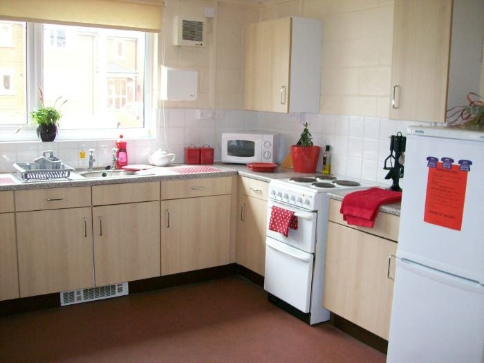 shared kitchen with red accessories