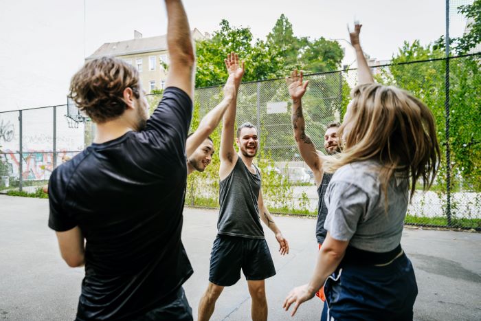 Young people high fiving from a distance 