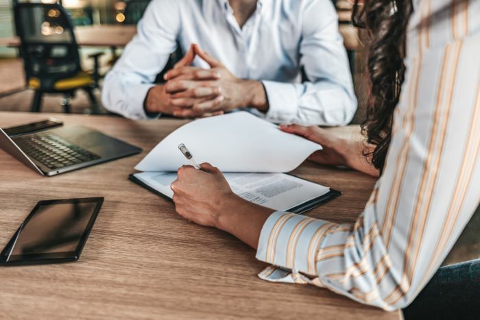 People talking at a desk.