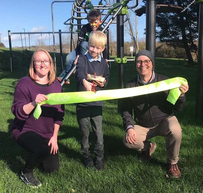 2 adults and 2 children in a play park