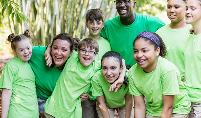 Adults and children dressed in green t-shirts