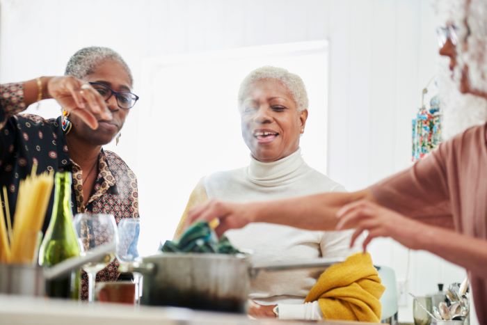 Ladies cooking in a kitchen. 