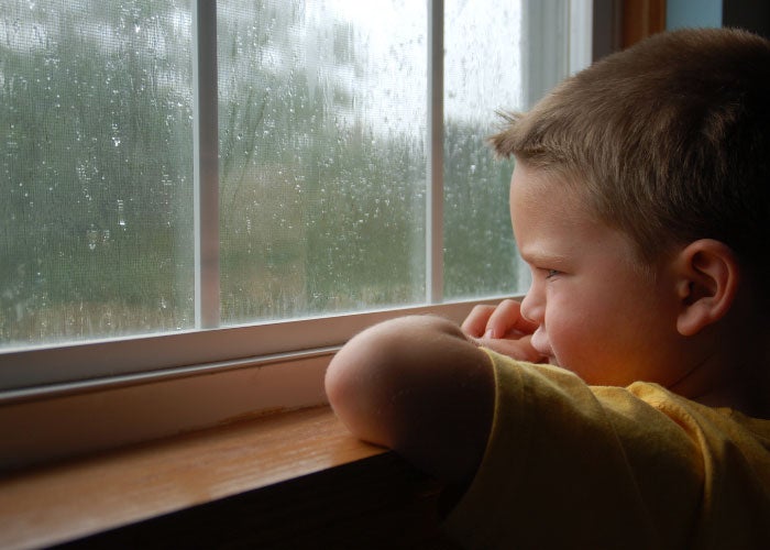 young boy looking out of window