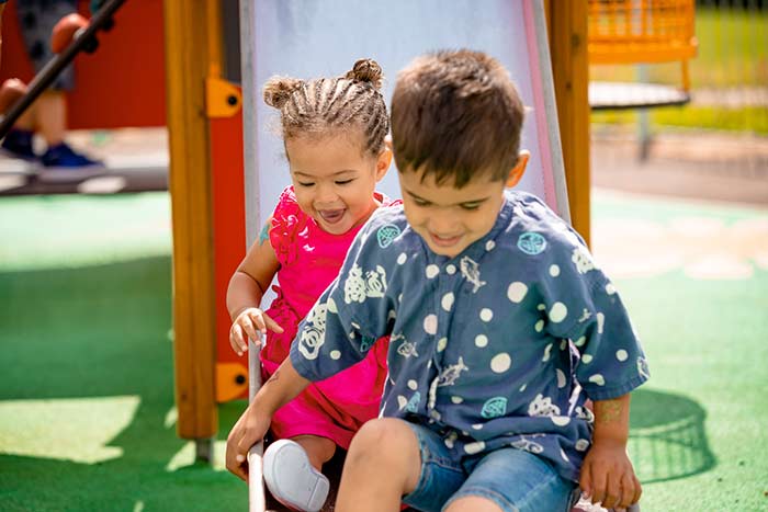 Two children on a slide