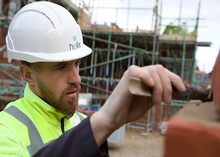 Helix bricklayer working on the new Swansea Road new builds