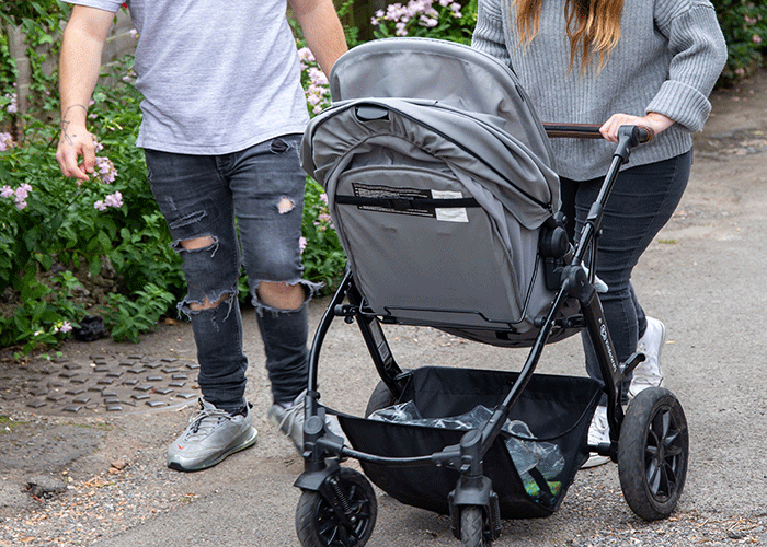 Couple walking with a buggy. 