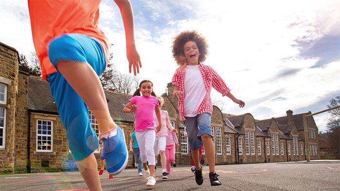 Group of children running in a playground