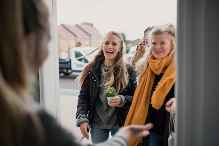 Two women greeting one another