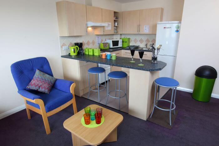 Kitchen area with a breakfast bar and chair with coffee table