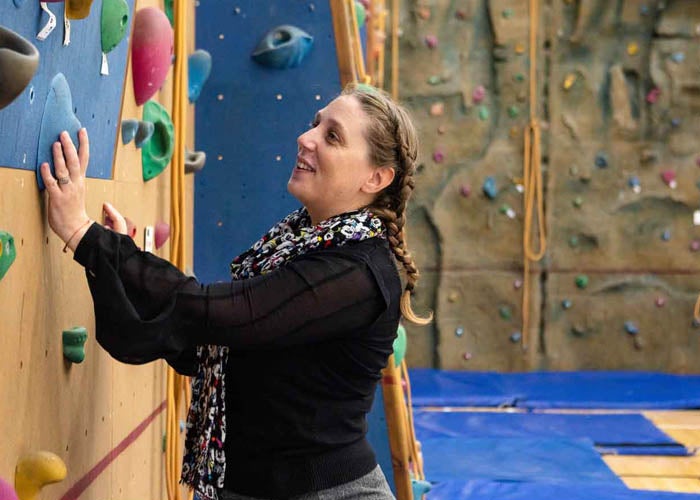 Rachel climbing a wall