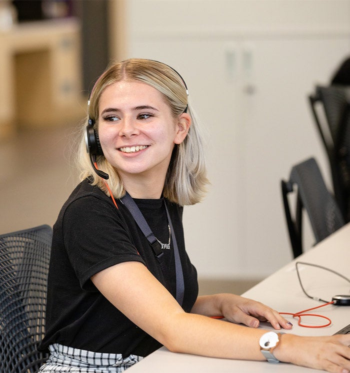 Sovereign employee wearing a headset and working at a desk