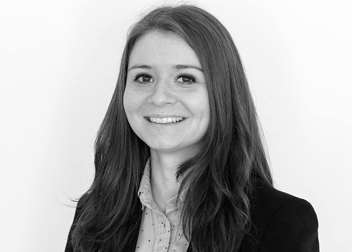 Black and white profile picture of a lady smiling at the camera