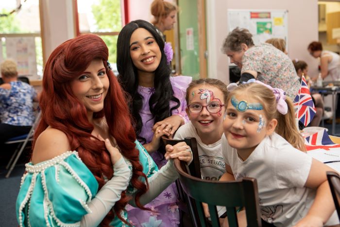 A group of people at a community event smiling at the camera