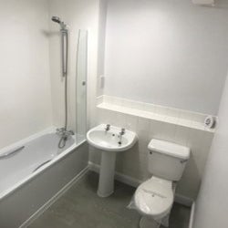Completed bathroom project with white fittings