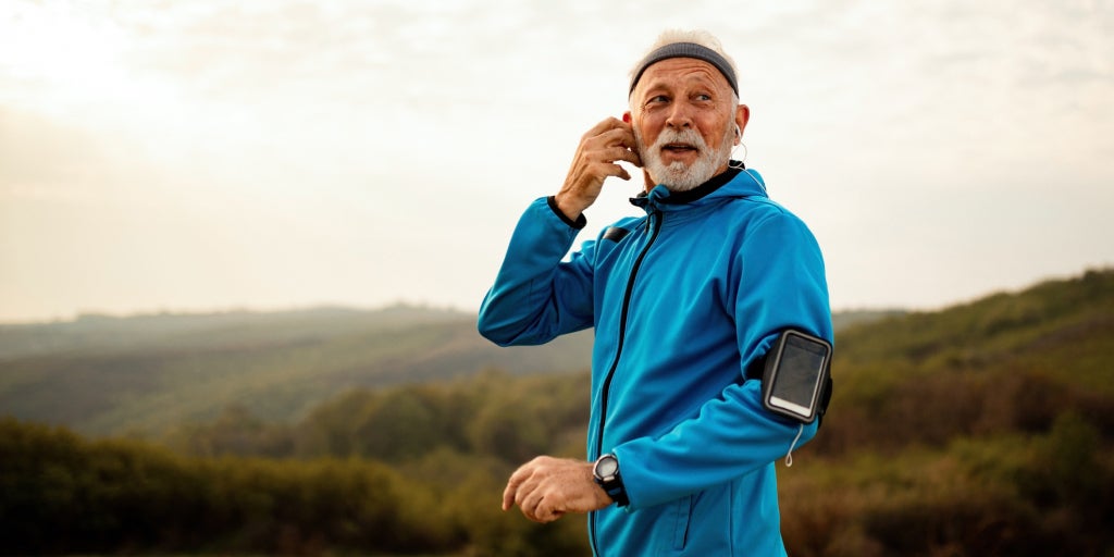 Man out running with mobile phone strapped to his arm