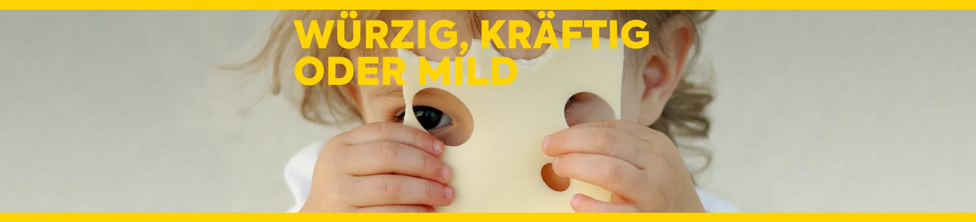 Ein kleines Kind hält eine Scheibe Emmentaler in der Hand und schaut durch die Löcher. Text: Würzig, kräftig oder mild