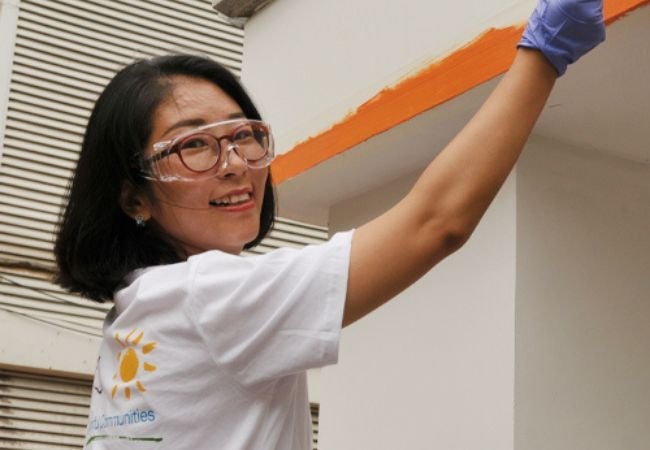 happy volunteer painting in Tianjin, China 