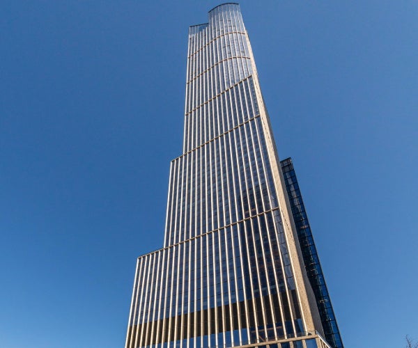 Photo spanning up the height of the Hudson building against a blue sky