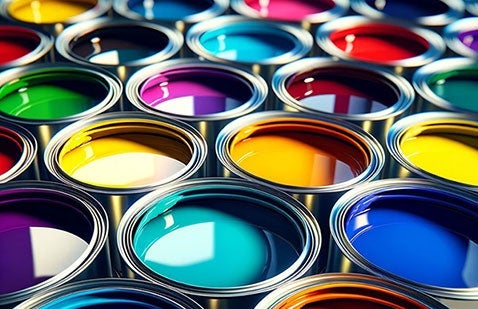 Selection of brightly colored paint in open cans