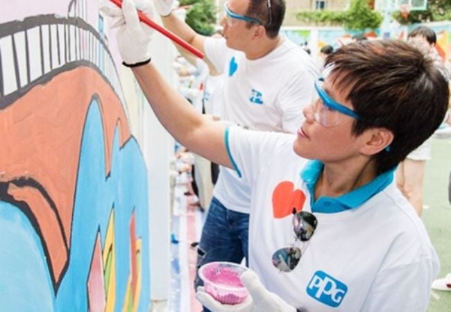 woman painting mural in Songjiang China 