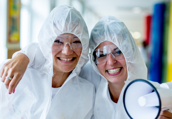 Two volunteers in white painting suits in Brno, Czech Republic 