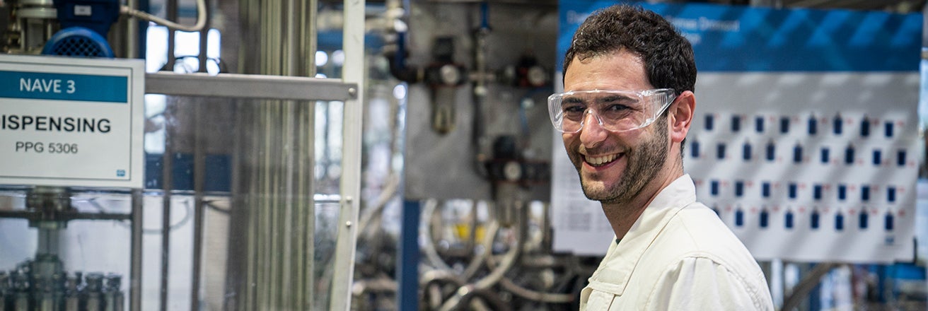 PPG employee wearing PPE within dispensing area of a plant