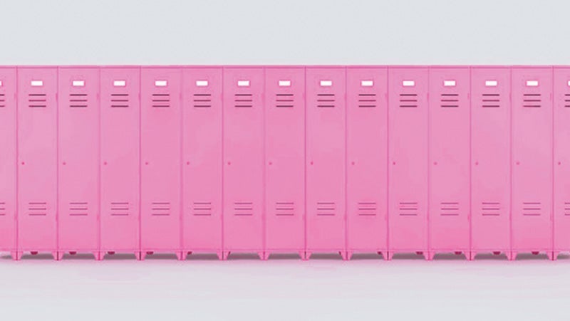 A continuous row of closed pink lockers with ventilation slots, set against a plain light background