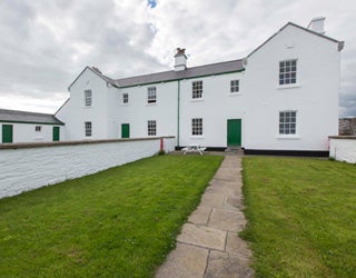A white building with a lawn
