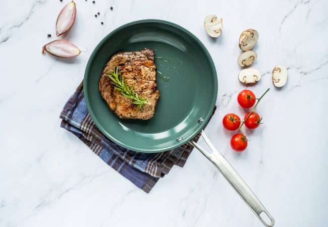 Green colored pan with steak