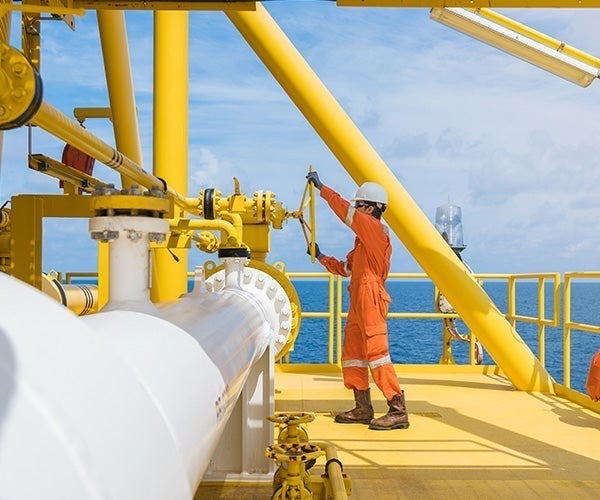 A man in orange jumpsuit on a yellow platform