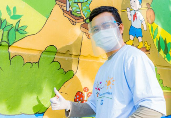 man standing in front of mural